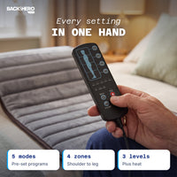 Hand holding the massage mat remote