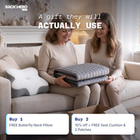 Two women unboxing the massage mat with the free Butterfly Neck Pillow on the sofa; Buy 2 adds a Seat Cushion and 2 Pain Relief Patches