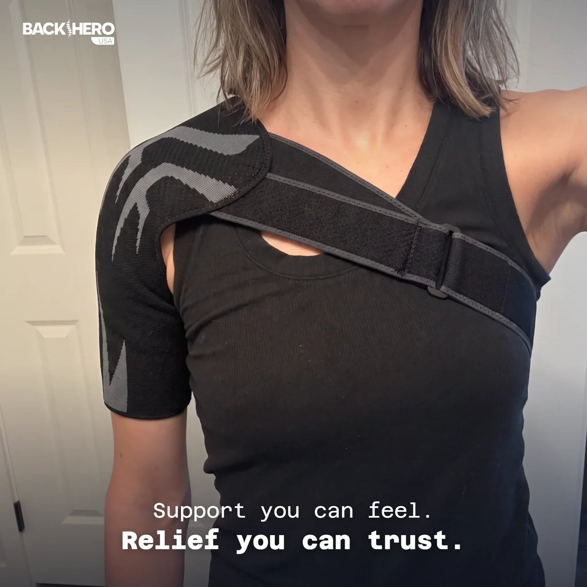 Woman wearing a black shoulder brace over a black top – support you can feel, relief you can trust