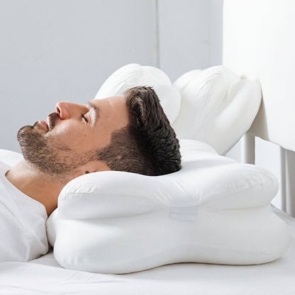 Man sleeping on his back on the ergonomic pillow